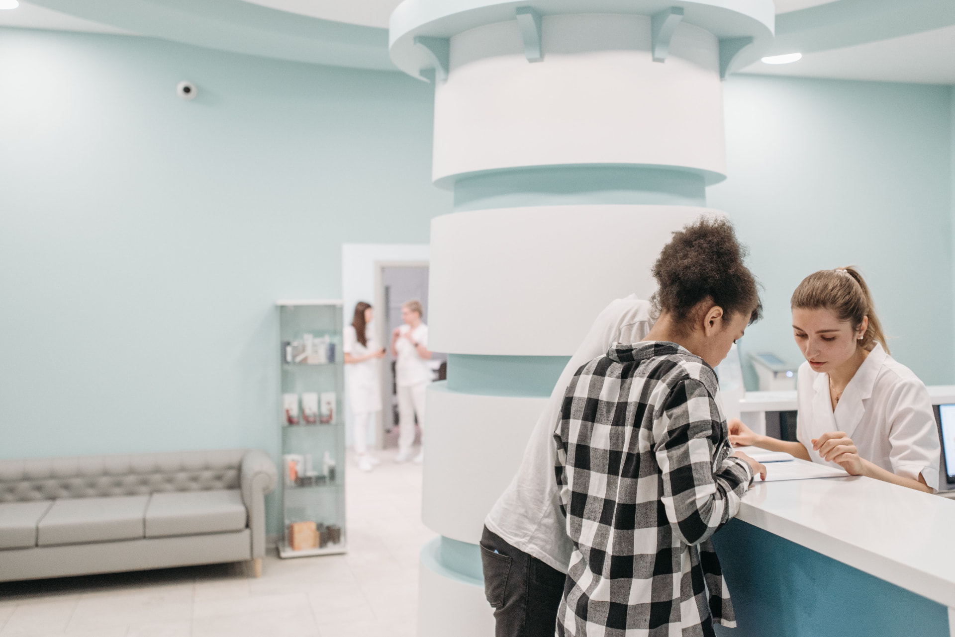 Patient checking in at a modern specialist clinic reception desk