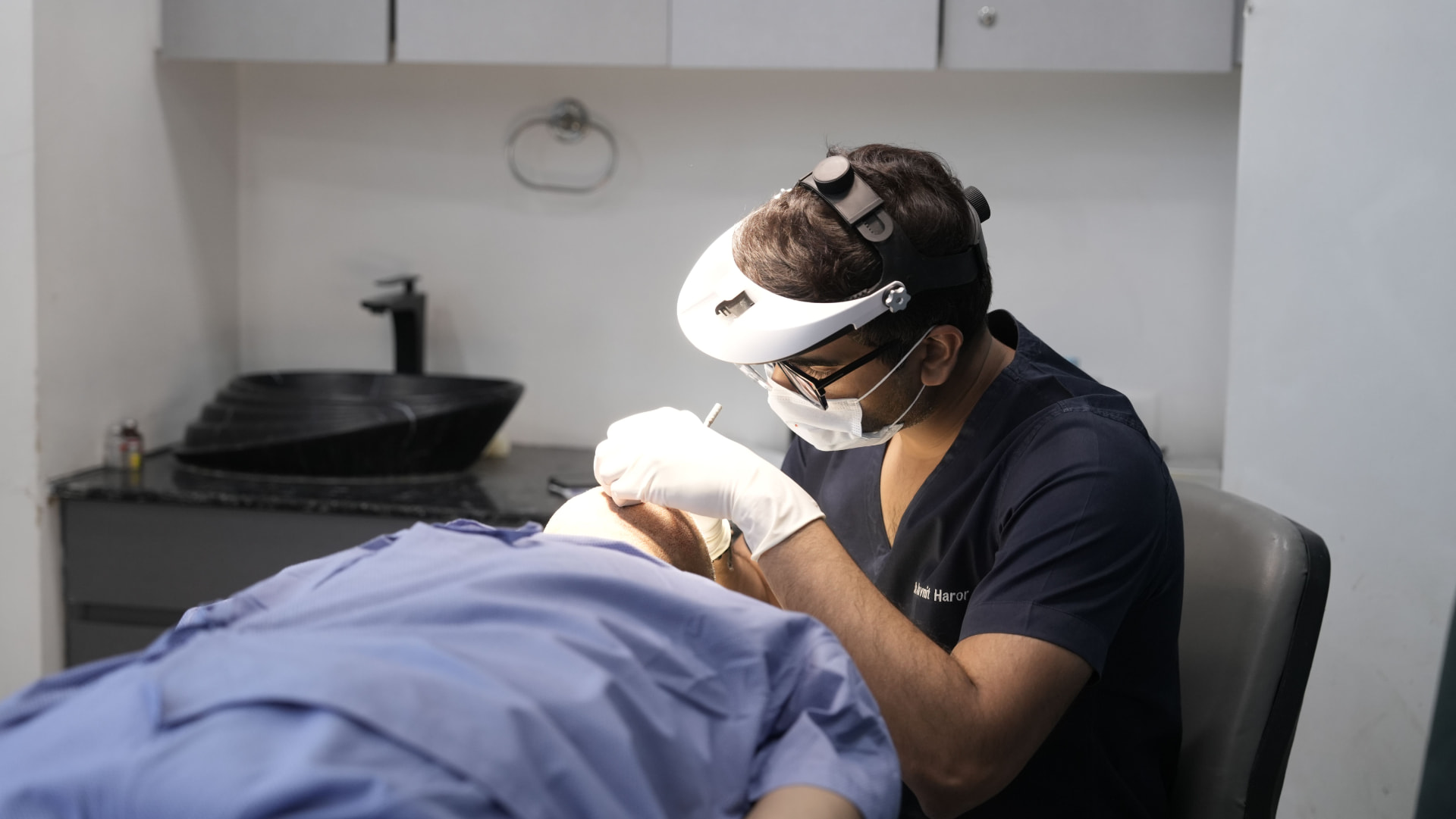 Clinician examining a patient in a private practice treatment room